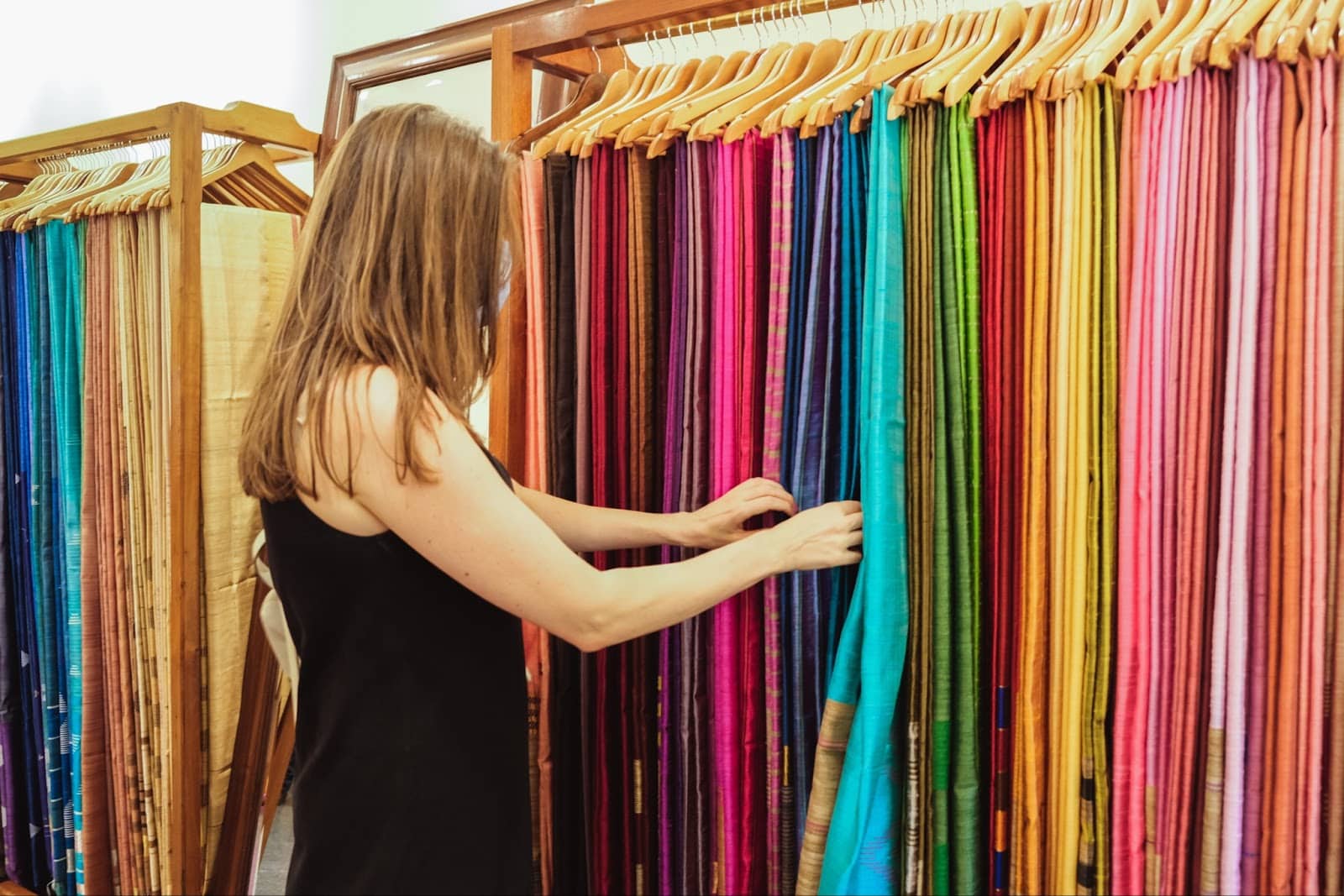 https://marshalldrygoods.com/wp-content/uploads/2024/09/a-woman-examines-fabrics-at-a-fabric-and-sarong-st-2022-01-26-16-21-25-utc.jpg