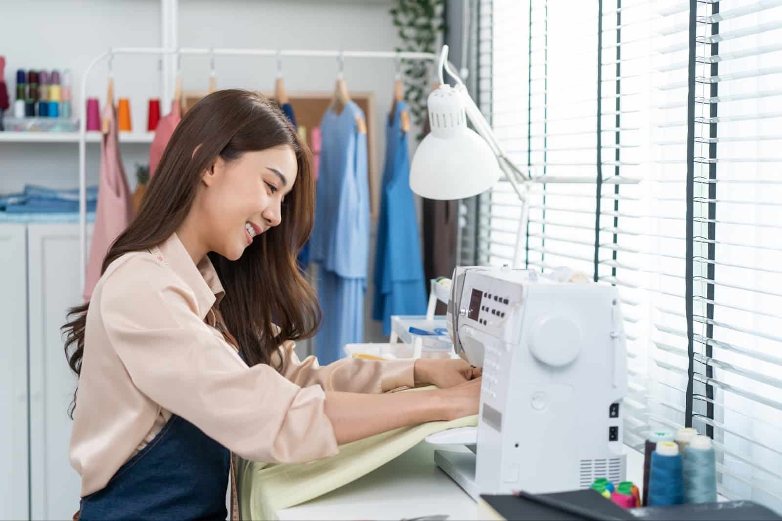 https://marshalldrygoods.com/wp-content/uploads/2024/09/asian-beautiful-tailor-woman-pushes-fabric-materia-2021-12-09-21-42-36-utc.jpg