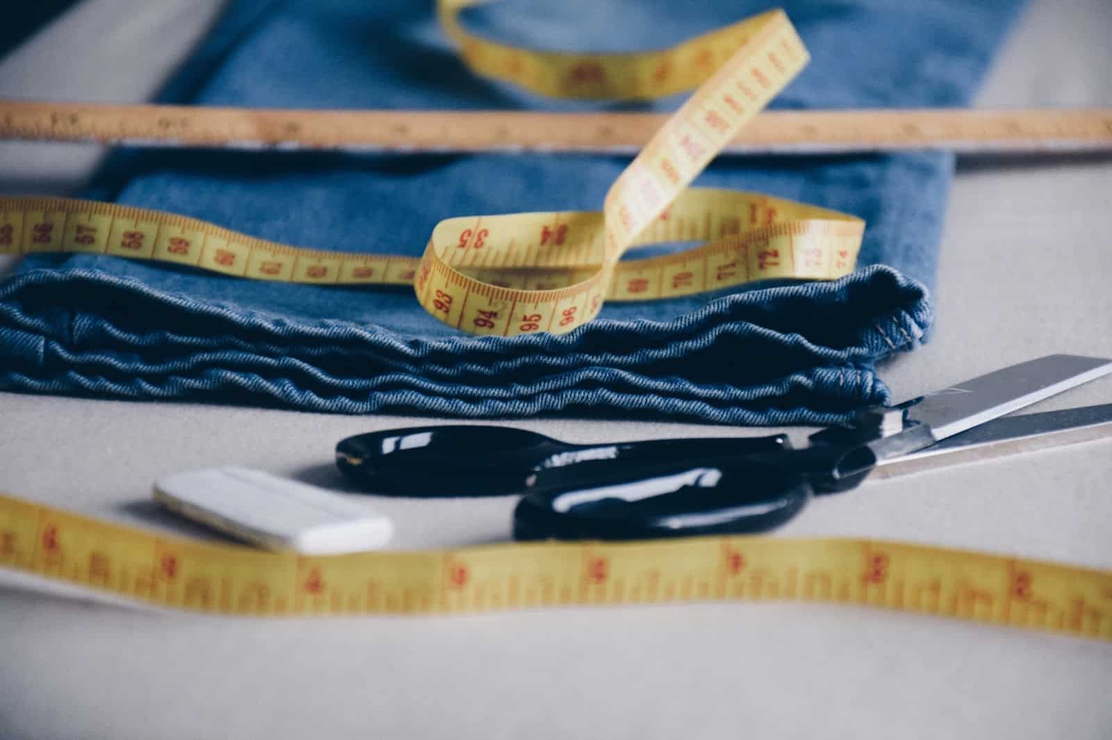 https://marshalldrygoods.com/wp-content/uploads/2024/09/jeans-to-be-hemmed-and-sewing-supplies-UXPU46Q.jpg