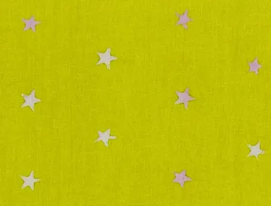 Yellow green cotton fabric with scattered pink and white star print pattern.